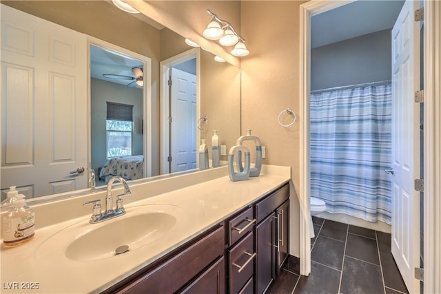 10319 Larkmead Ave, Las Vegas, NV 89149 - ensuite bathroom featuring toilet, vanity, tile patterned floors, ceiling fan, and a shower with shower curtain