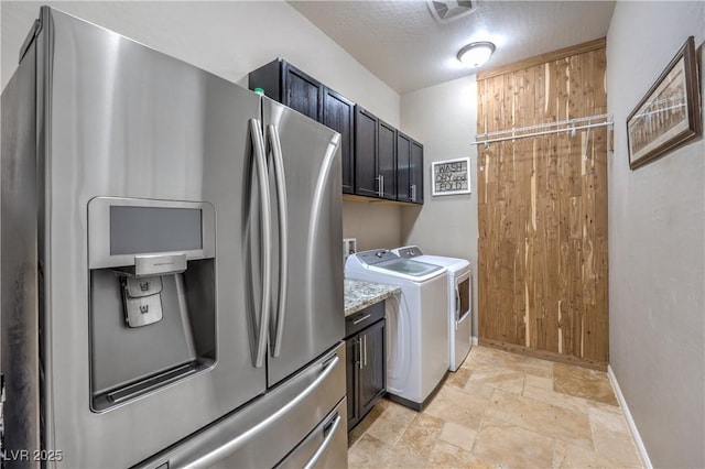 10319 Larkmead Ave, Las Vegas, NV 89149 - washroom featuring baseboards, stone tile flooring, washing machine and dryer, and cabinet space