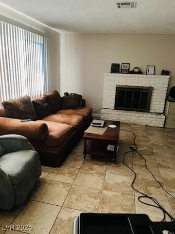 3382 Berwyck St, Las Vegas, NV 89121 - living area featuring a brick fireplace and a textured ceiling