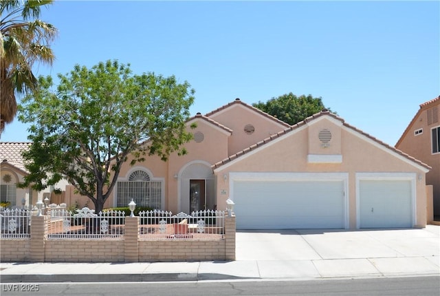 3519 W Red Coach Ave, North Las Vegas, NV 89031 - mediterranean / spanish home with an attached garage, driveway, stucco siding, and a tiled roof