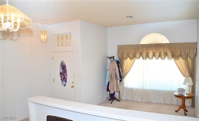 3519 W Red Coach Ave, North Las Vegas, NV 89031 - entryway with carpet and a chandelier