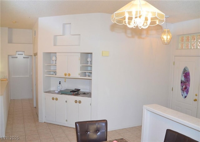 3519 W Red Coach Ave, North Las Vegas, NV 89031 - kitchen with open shelves, a chandelier, light tile patterned flooring, and white cabinets