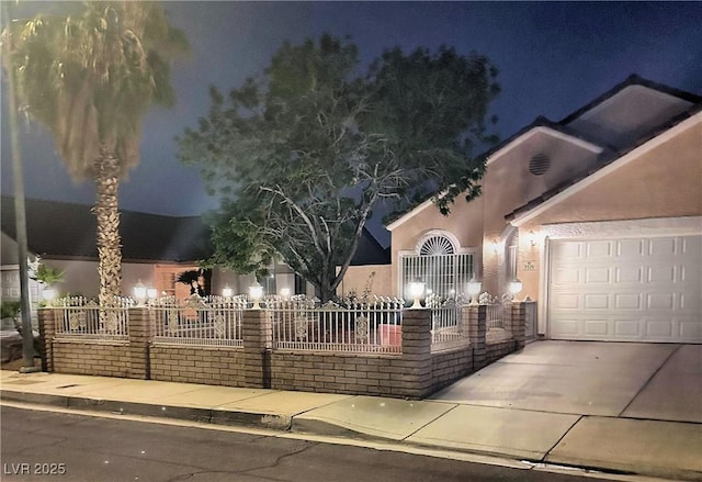 3519 W Red Coach Ave, North Las Vegas, NV 89031 - view of front of property featuring stucco siding, a garage, and concrete driveway