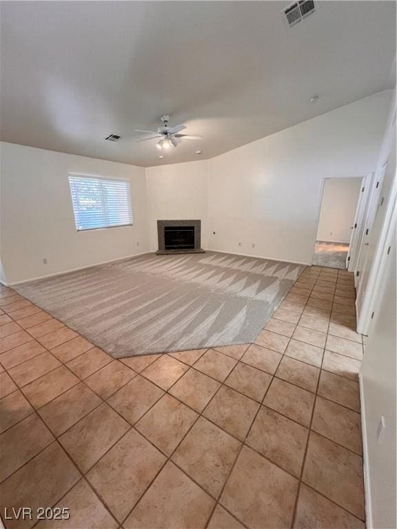 7255 W La Madre Way, Las Vegas, NV 89149 - unfurnished living room featuring tile patterned floors, ceiling fan, a fireplace, and carpet floors