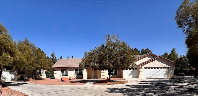 7255 W La Madre Way, Las Vegas, NV 89149 - view of front facade featuring an attached garage, concrete driveway, stucco siding, and a tile roof