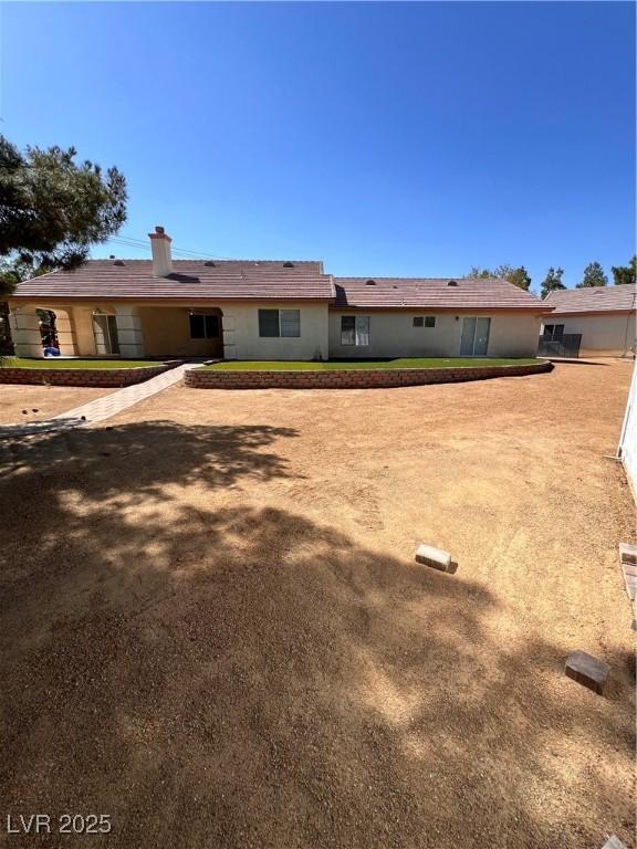 7255 W La Madre Way, Las Vegas, NV 89149 - back of house with a chimney
