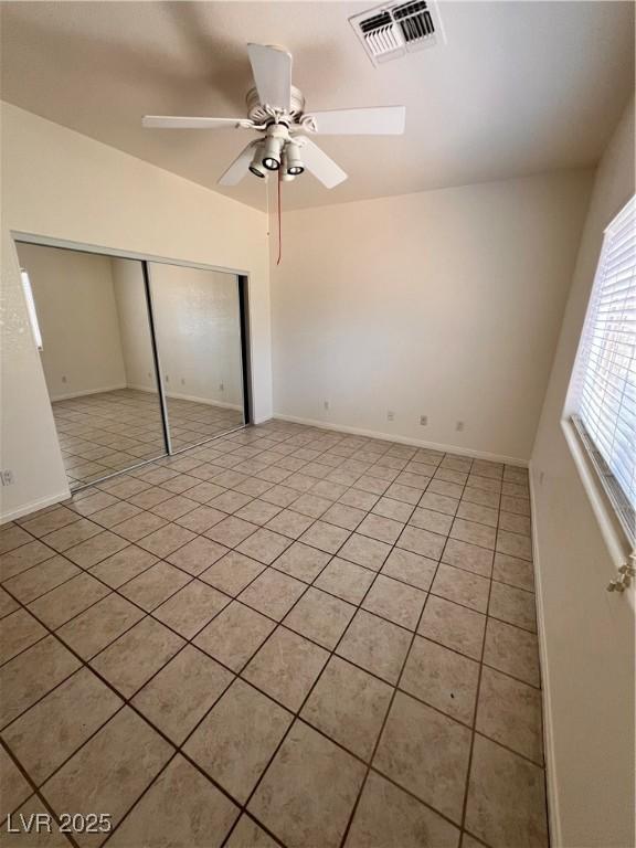 7255 W La Madre Way, Las Vegas, NV 89149 - unfurnished bedroom featuring light tile patterned flooring, a closet, baseboards, and ceiling fan