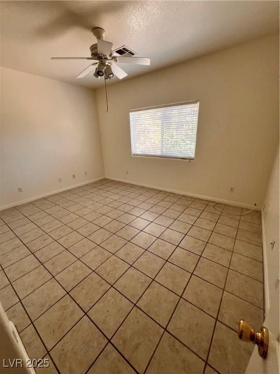 7255 W La Madre Way, Las Vegas, NV 89149 - empty room with light tile patterned floors, a ceiling fan, and baseboards