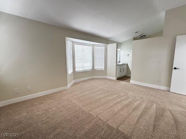 3005 Treasure Island Rd, Las Vegas, NV 89128 - spare room with lofted ceiling, light colored carpet, and baseboards