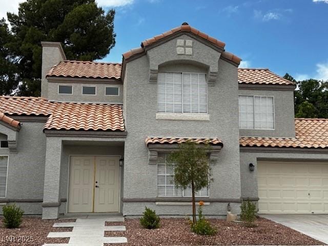 3005 Treasure Island Rd, Las Vegas, NV 89128 - mediterranean / spanish home featuring a tiled roof, stucco siding, and concrete driveway