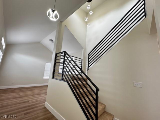 3005 Treasure Island Rd, Las Vegas, NV 89128 - stairway with baseboards, wood finished floors, and lofted ceiling