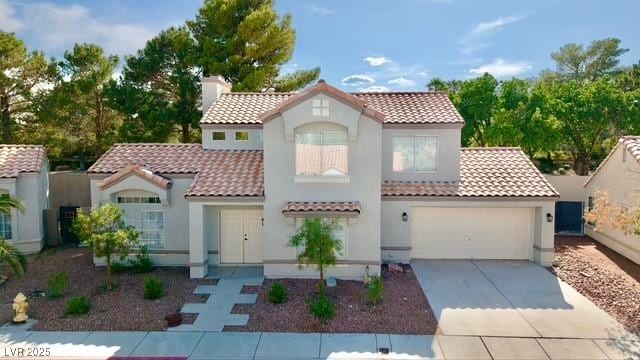 3005 Treasure Island Rd, Las Vegas, NV 89128 - mediterranean / spanish house featuring a tiled roof, concrete driveway, and stucco siding