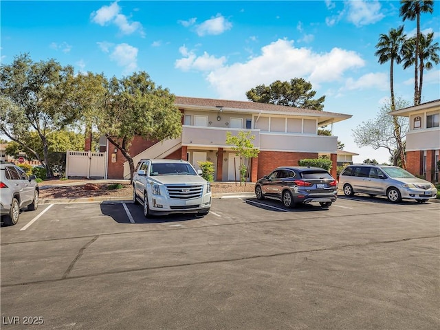 2867 Geary Pl Unit 3008, Las Vegas, NV 89109 - view of front facade with uncovered parking, brick siding, and stucco siding