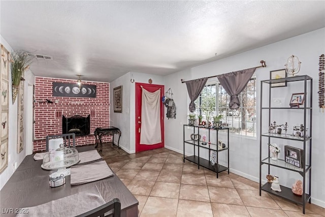 201 Cervantes St, Las Vegas, NV 89101 - living area featuring a fireplace, baseboards, and tile patterned flooring