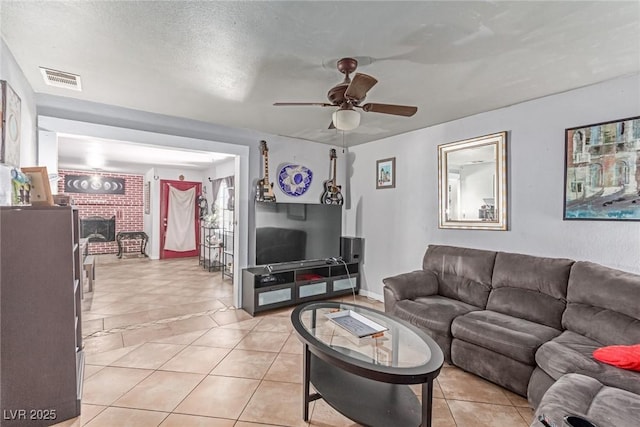 201 Cervantes St, Las Vegas, NV 89101 - living area with a ceiling fan, light tile patterned floors, and a fireplace
