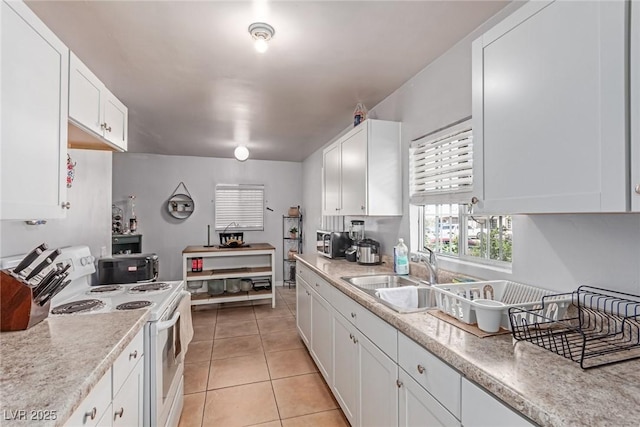 201 Cervantes St, Las Vegas, NV 89101 - kitchen with white electric range oven, white cabinetry, a sink, and light countertops