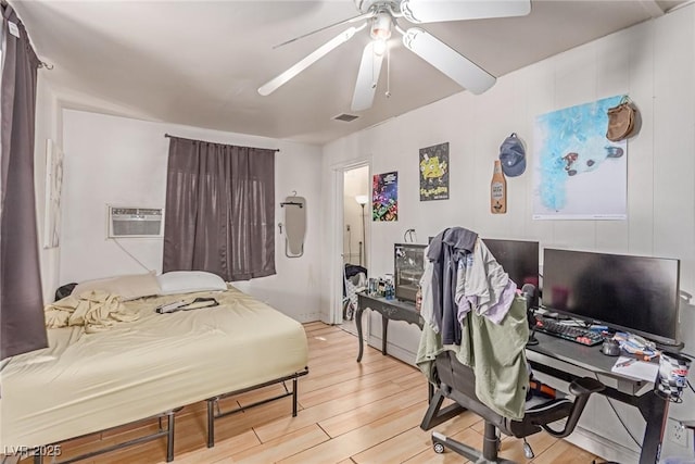 201 Cervantes St, Las Vegas, NV 89101 - bedroom with light wood-style floors, a ceiling fan, an office area, and a wall unit AC
