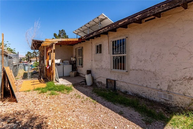 201 Cervantes St, Las Vegas, NV 89101 - view of side of home with washer and dryer and stucco siding
