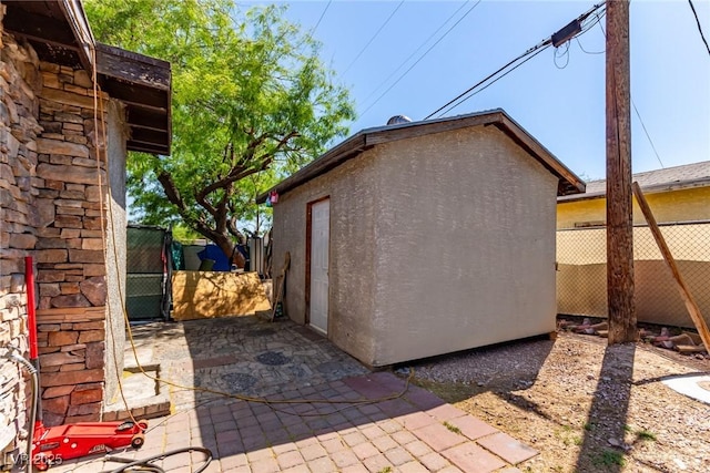201 Cervantes St, Las Vegas, NV 89101 - view of side of home featuring stucco siding, a gate, and an outbuilding