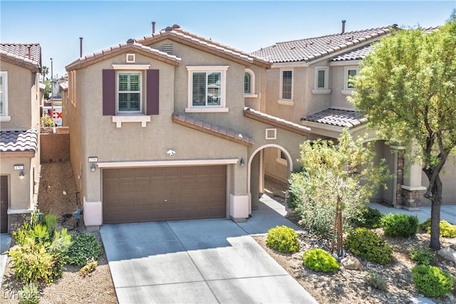 4786 Castel Martini Ct, Las Vegas, NV 89147 - view of front facade featuring a tiled roof, stucco siding, a garage, and driveway