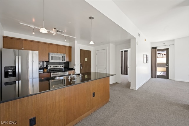 29 Montelago Blvd Unit 520, Henderson, NV 89011 - kitchen with appliances with stainless steel finishes, dark countertops, brown cabinetry, light carpet, and a sink