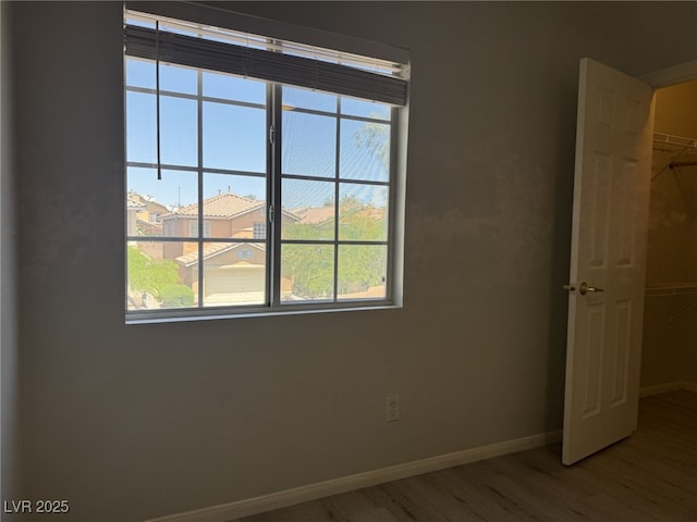 11029 Meadow Leaf Ave, Las Vegas, NV 89144 - unfurnished bedroom with wood finished floors, baseboards, multiple windows, and a closet