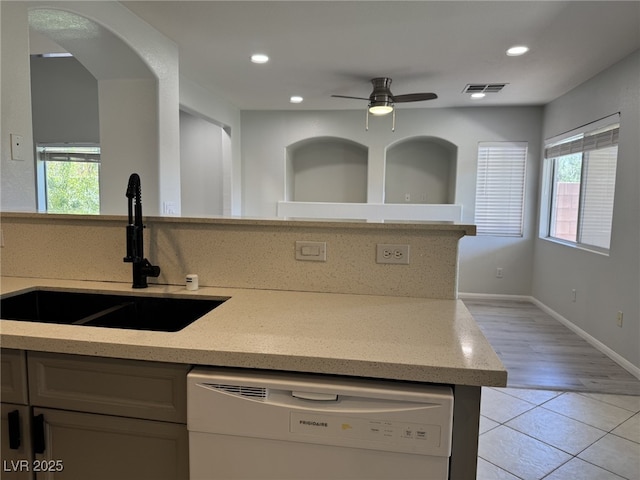 11029 Meadow Leaf Ave, Las Vegas, NV 89144 - kitchen featuring white dishwasher, a sink, light stone countertops, light tile patterned floors, and recessed lighting