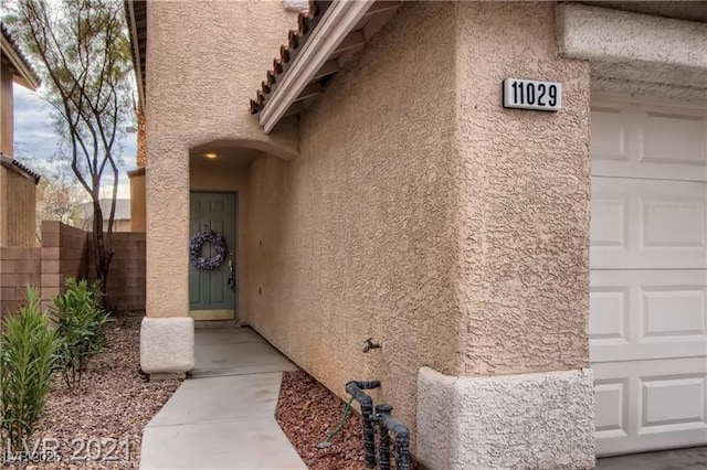 11029 Meadow Leaf Ave, Las Vegas, NV 89144 - doorway to property featuring stucco siding and a garage