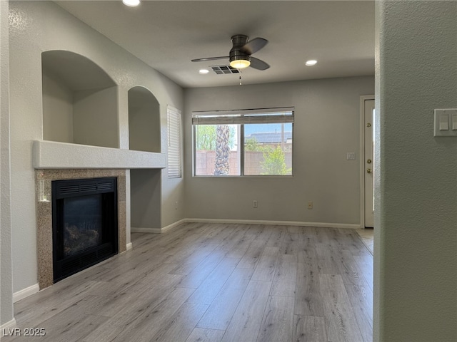 11029 Meadow Leaf Ave, Las Vegas, NV 89144 - unfurnished living room featuring wood finished floors, ceiling fan, a tile fireplace, recessed lighting, and baseboards