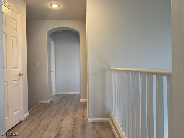 11029 Meadow Leaf Ave, Las Vegas, NV 89144 - corridor with arched walkways, light wood finished floors, and baseboards