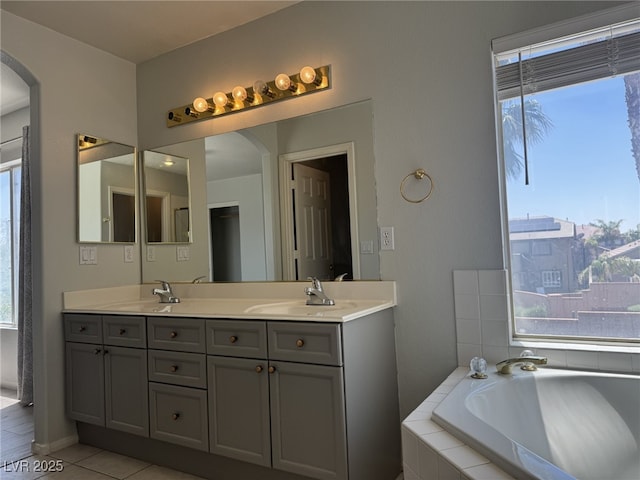 11029 Meadow Leaf Ave, Las Vegas, NV 89144 - bathroom with plenty of natural light, double vanity, a bath, and tile patterned flooring