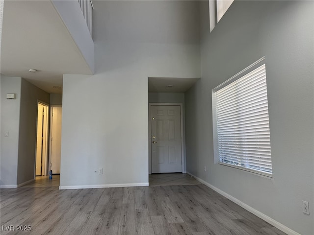 11029 Meadow Leaf Ave, Las Vegas, NV 89144 - empty room featuring a towering ceiling, wood finished floors, and baseboards