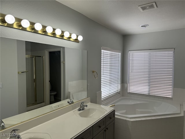 11029 Meadow Leaf Ave, Las Vegas, NV 89144 - bathroom with a garden tub, a stall shower, double vanity, and plenty of natural light