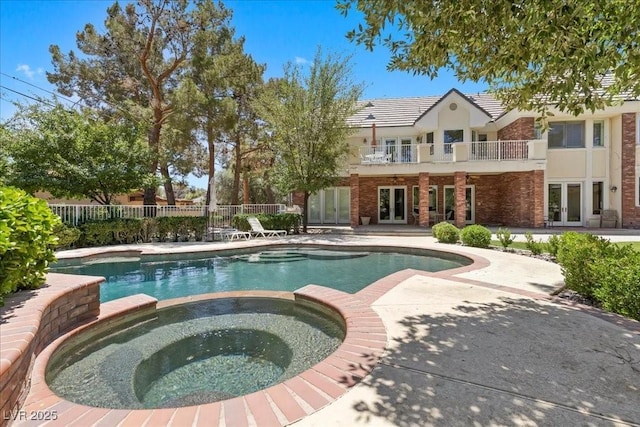 3102 La Mirada Ave, Las Vegas, NV 89120 - view of swimming pool with french doors, a pool with connected hot tub, and a patio area