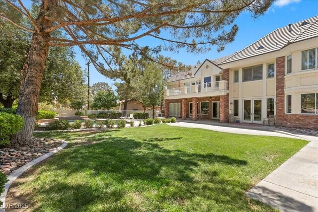 3102 La Mirada Ave, Las Vegas, NV 89120 - view of green lawn featuring french doors and a balcony