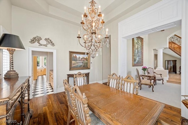 3102 La Mirada Ave, Las Vegas, NV 89120 - dining area with dark wood-style flooring, a chandelier, and decorative columns