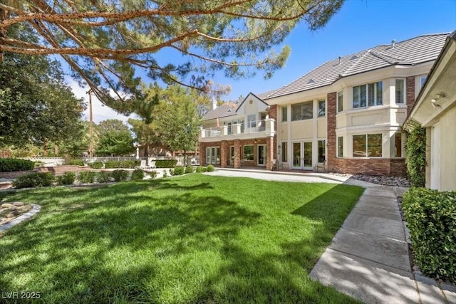 3102 La Mirada Ave, Las Vegas, NV 89120 - view of green lawn with french doors and a balcony