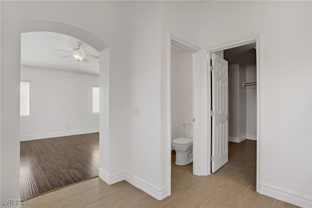 236 Dog Leg Dr, Las Vegas, NV 89148 - hall with wood finished floors, healthy amount of natural light, arched walkways, and baseboards