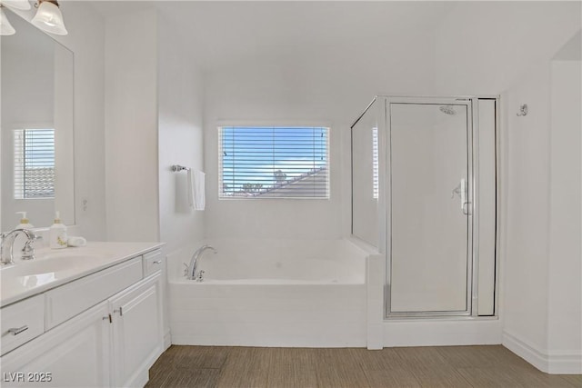 236 Dog Leg Dr, Las Vegas, NV 89148 - bathroom with vanity, a bath, a shower stall, and wood finished floors
