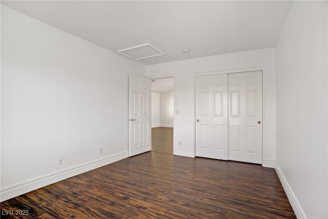 236 Dog Leg Dr, Las Vegas, NV 89148 - unfurnished bedroom with attic access, dark wood finished floors, and baseboards