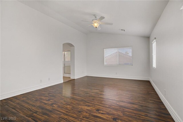 236 Dog Leg Dr, Las Vegas, NV 89148 - spare room with arched walkways, vaulted ceiling, a ceiling fan, dark wood-type flooring, and baseboards