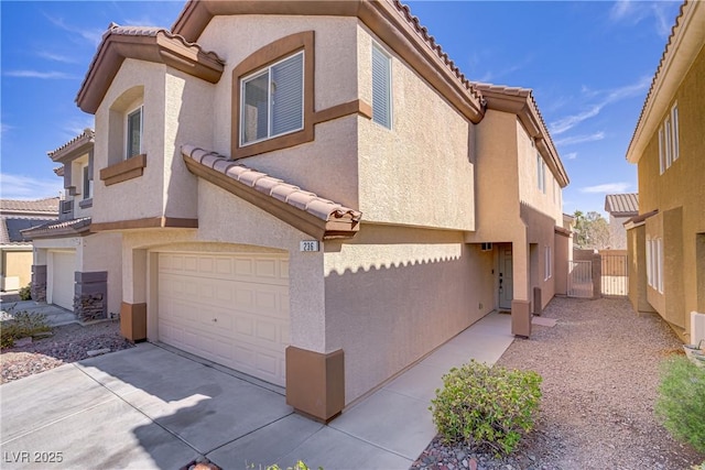 236 Dog Leg Dr, Las Vegas, NV 89148 - view of home's exterior featuring a tiled roof, stucco siding, a garage, and concrete driveway