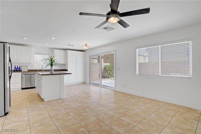 236 Dog Leg Dr, Las Vegas, NV 89148 - kitchen featuring dishwasher, freestanding refrigerator, dark countertops, healthy amount of natural light, and recessed lighting