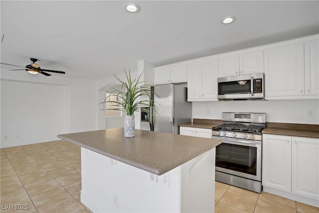 236 Dog Leg Dr, Las Vegas, NV 89148 - kitchen featuring appliances with stainless steel finishes, dark countertops, white cabinets, recessed lighting, and a ceiling fan