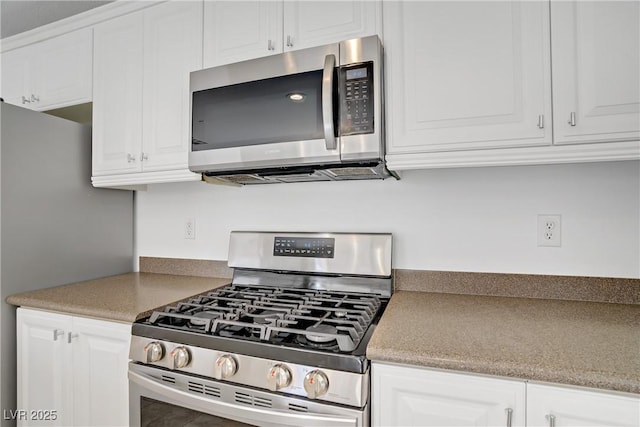 236 Dog Leg Dr, Las Vegas, NV 89148 - kitchen featuring stainless steel appliances and white cabinetry