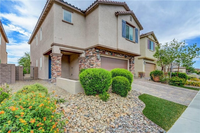 6334 Orions Belt Peak St, North Las Vegas, NV 89031 - view of front facade featuring stone siding, an attached garage, stucco siding, and a tiled roof
