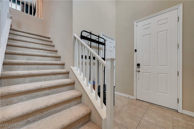 6334 Orions Belt Peak St, North Las Vegas, NV 89031 - foyer with stairway, baseboards, light tile patterned floors, and a high ceiling