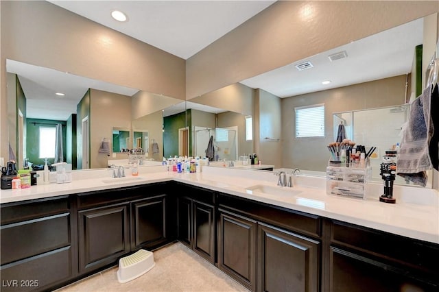 6334 Orions Belt Peak St, North Las Vegas, NV 89031 - bathroom with a stall shower, double vanity, and recessed lighting