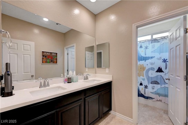 6334 Orions Belt Peak St, North Las Vegas, NV 89031 - bathroom with double vanity, tile patterned flooring, curtained shower, and baseboards