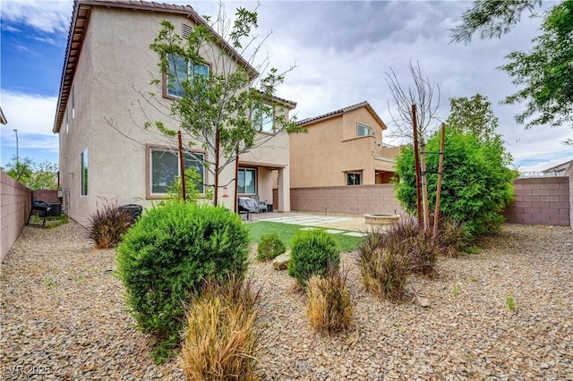 6334 Orions Belt Peak St, North Las Vegas, NV 89031 - back of house featuring stucco siding, a fenced backyard, and a patio area